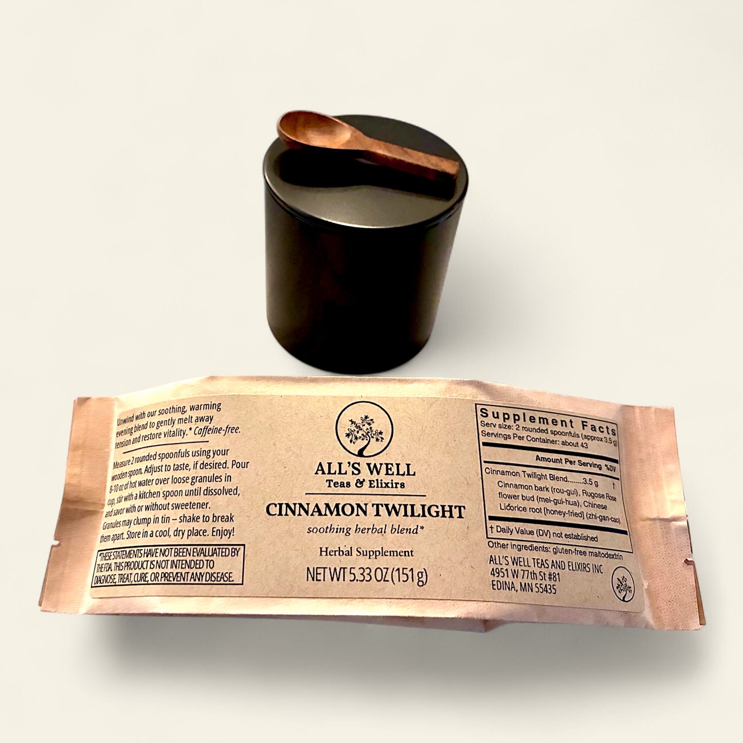 All's Well Teas and Elixirs Cinnamon Twilight - Our soothing, warming evening blend to gently melt away tension and restore vitality.

Herbal supplement package with a black tin and wooden spoon on a white background