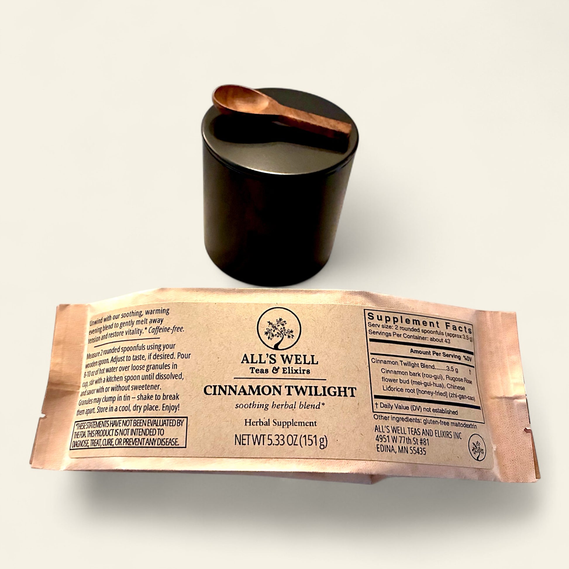 All's Well Teas and Elixirs Cinnamon Twilight - Our soothing, warming evening blend to gently melt away tension and restore vitality.

Herbal supplement package with a black tin and wooden spoon on a white background