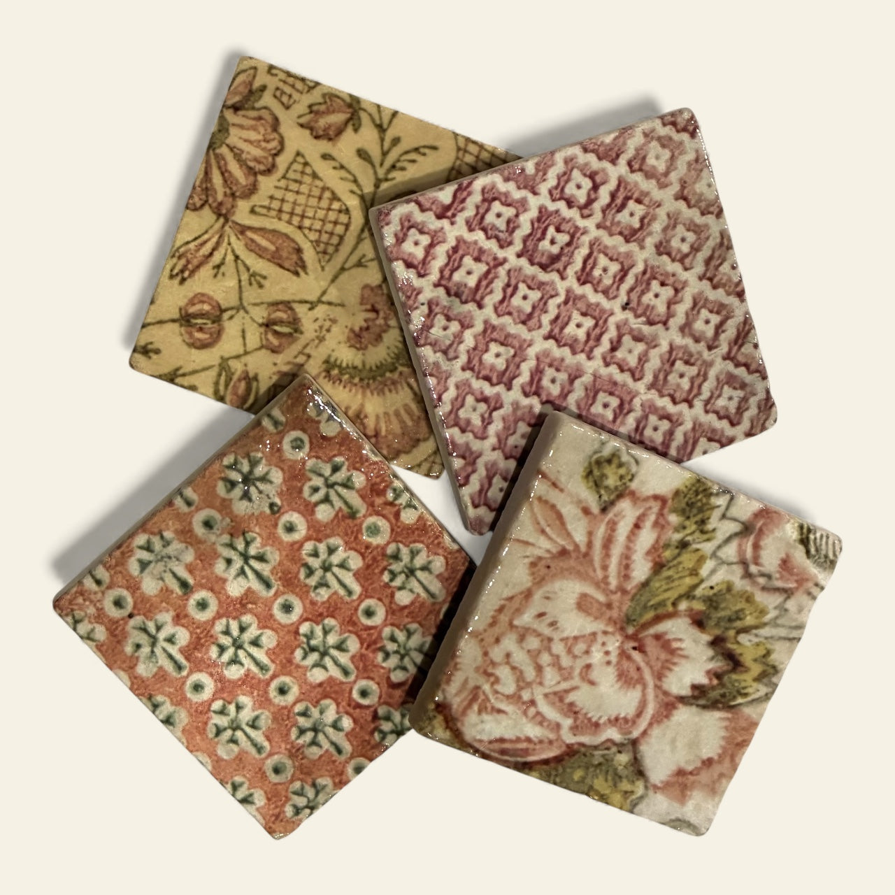 Four patterned coasters on a light background