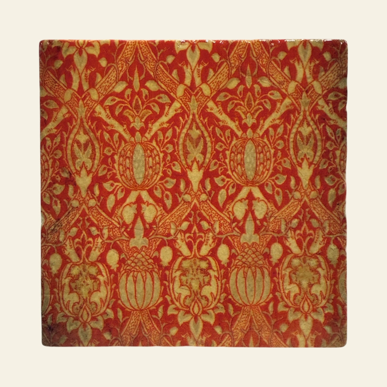 Antique Red stone coaster against a beige background