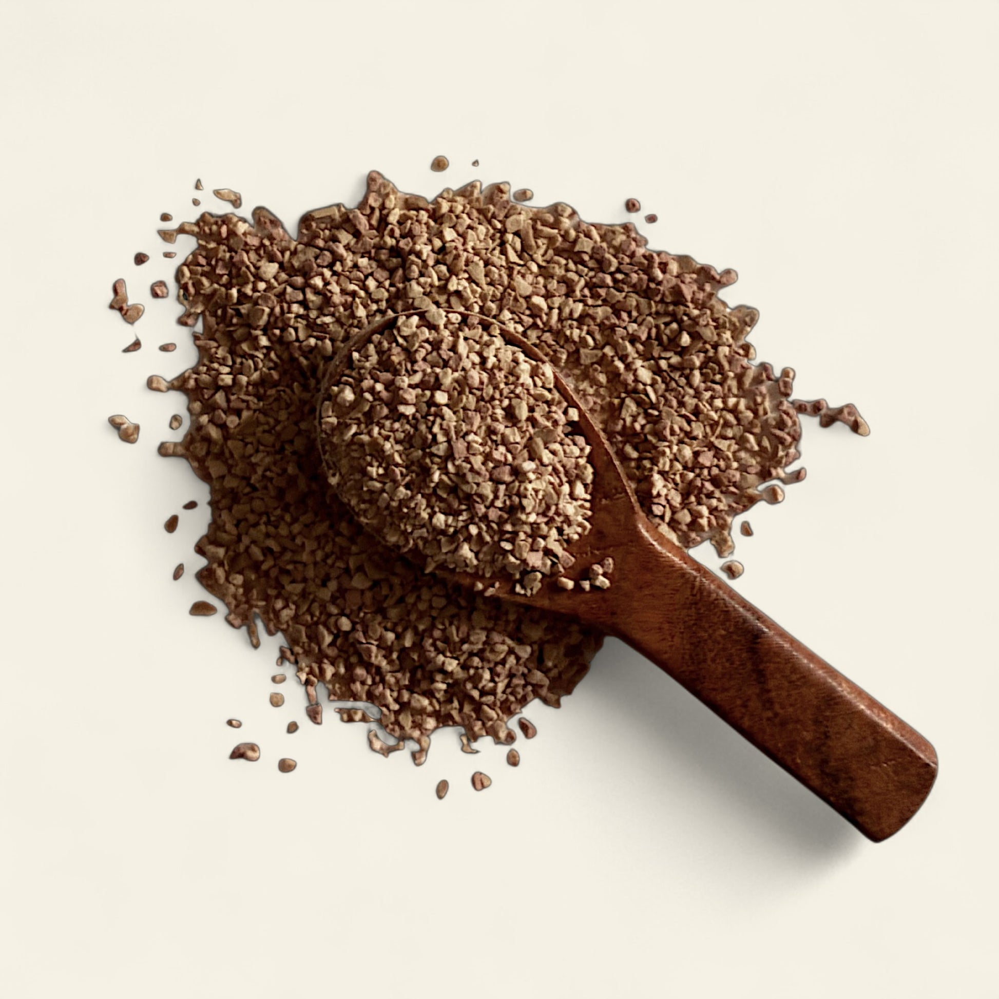 All's Well Teas and Elixirs Warm the Source - Our comforting, nourishing blend to warm the core, ground, and soothe from within.

Wooden scoop filled with a granulated tea blend on a light beige background